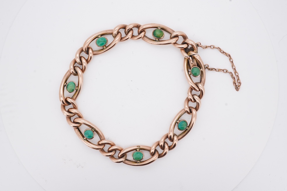 An early 20th century yellow metal (stamped 9c) and seven stone cabochon turquoise set curb link bracelet, 19cm, gross weight 14 grams. Condition - poor to fair